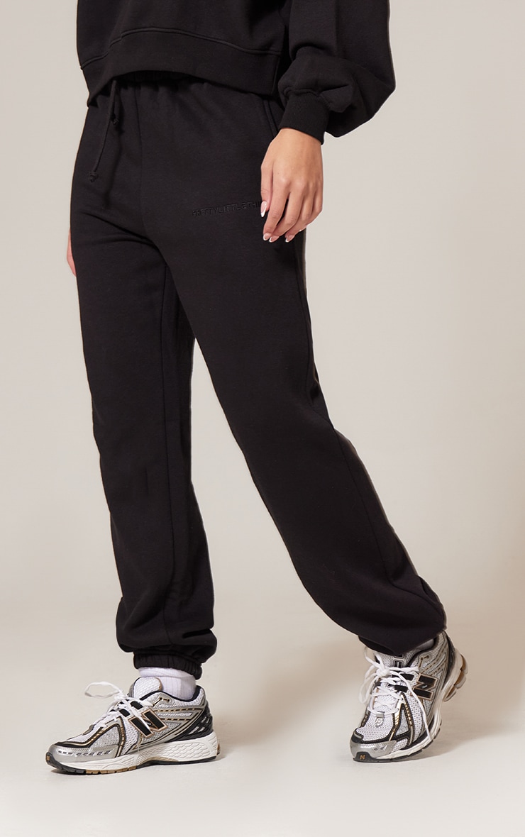PRETTYLITTLETHING Black Oversized Embroidered Cuffed Sweatpants image 1