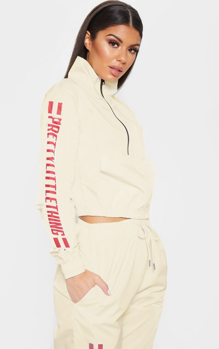 PRETTYLITTLETHING Cream Logo Stripe Shell Zip Up Top