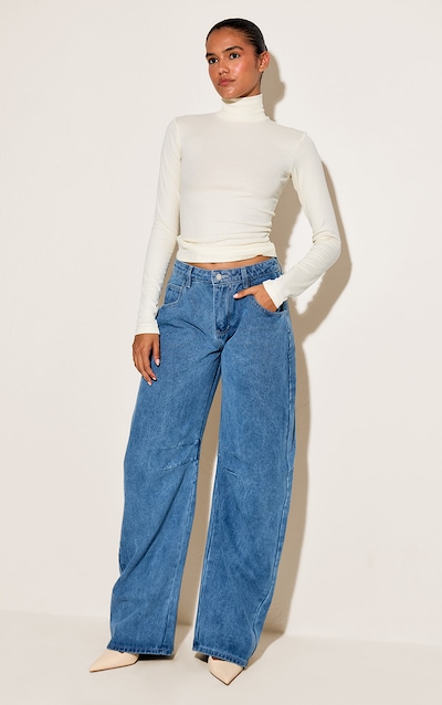 Jean style bouffant bleu moyen délavé à taille basse et coutures devant