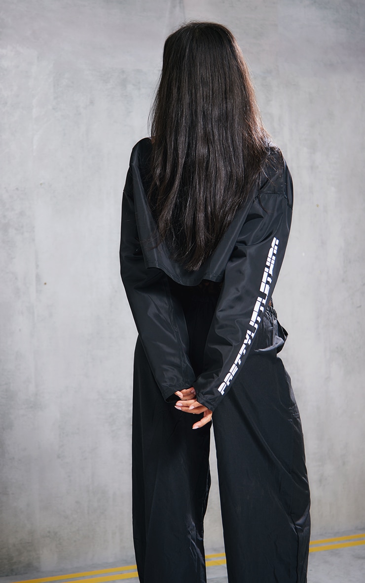 PRETTYLITTLETHING Black Slogan Boxy Cropped Windbreaker Jacket image 2