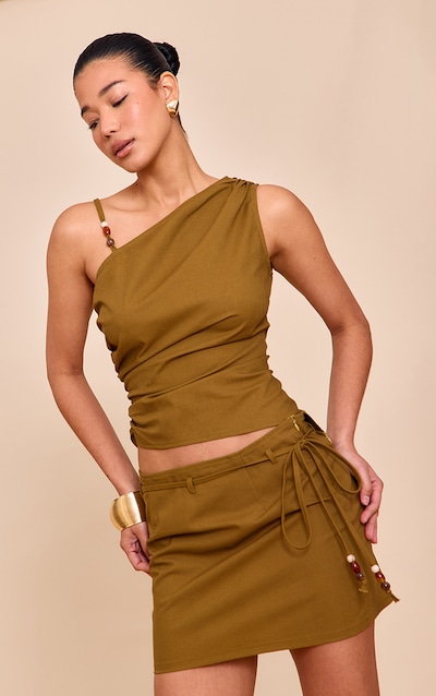 Top vert olive à empiècements asymétriques