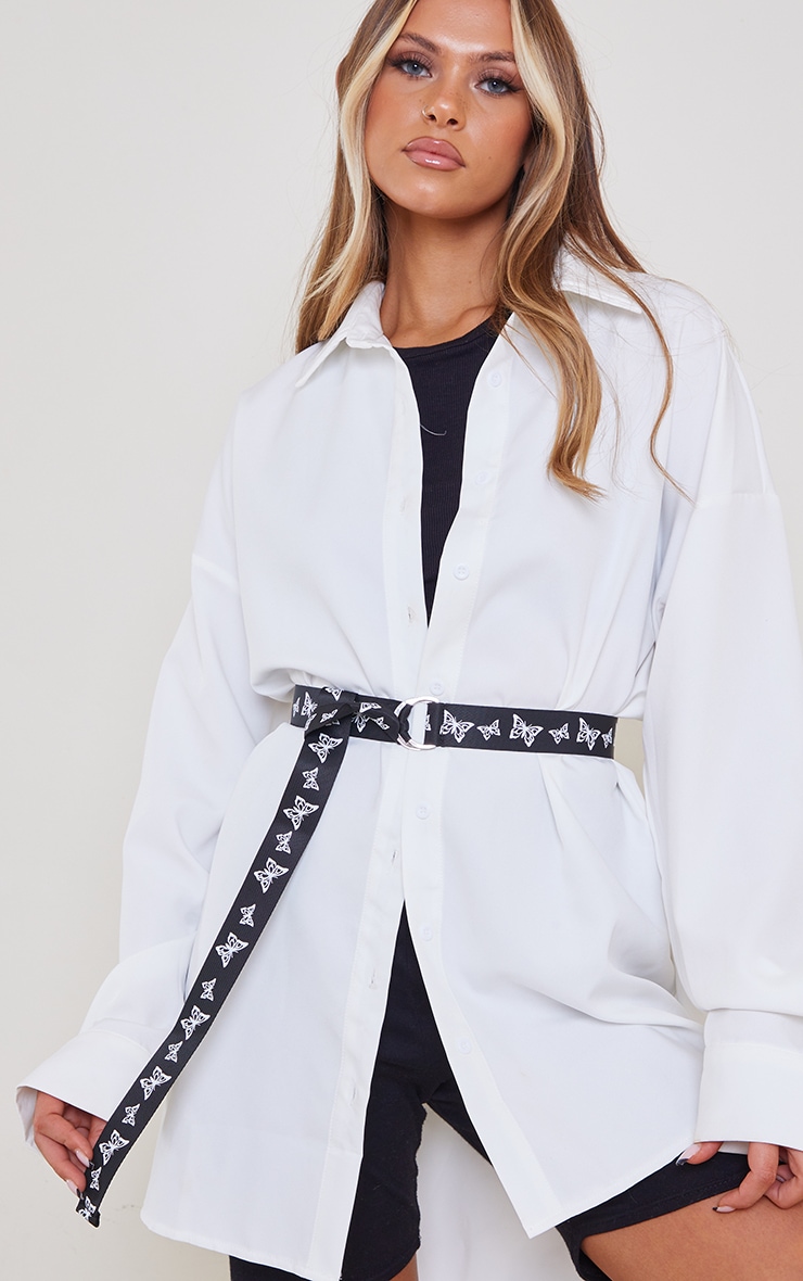 Ceinture sangle noire à papillons blancs