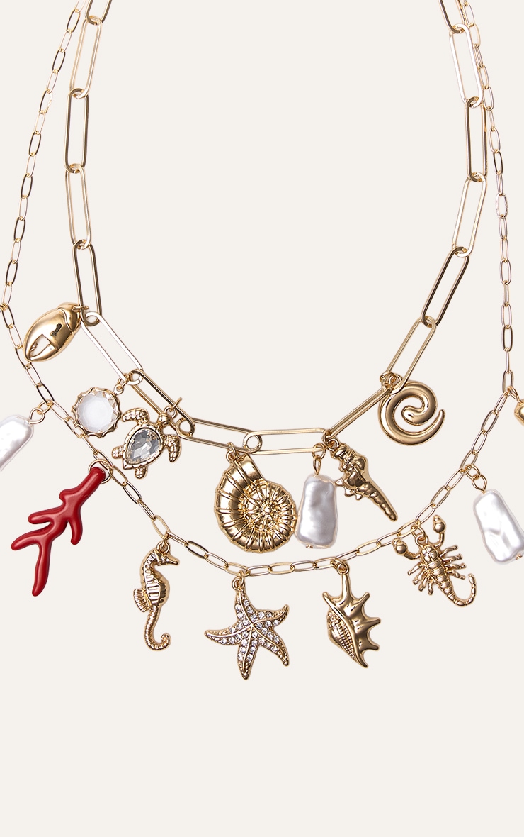 Collier superposé doré à pendentifs breloques variées image 3