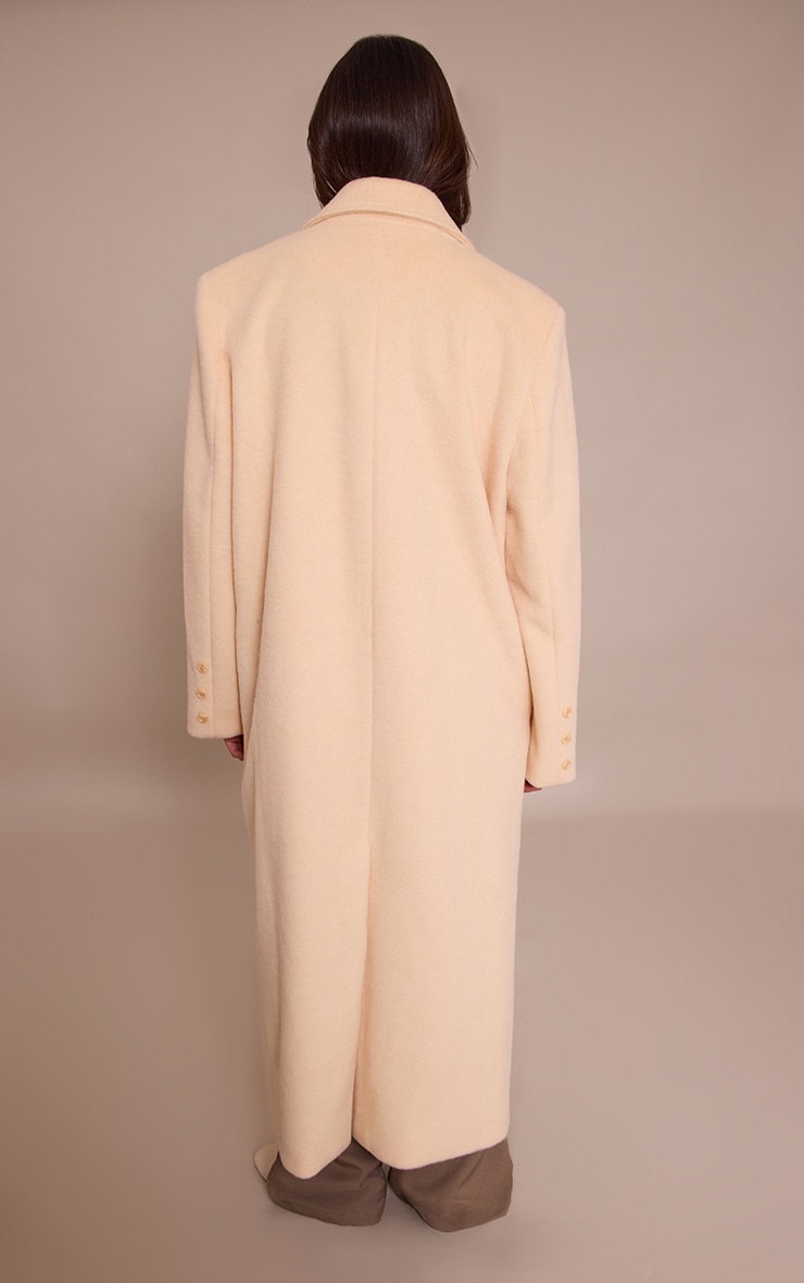 Manteau long structuré en effet laine crème au beurre à double boutonnière image 2