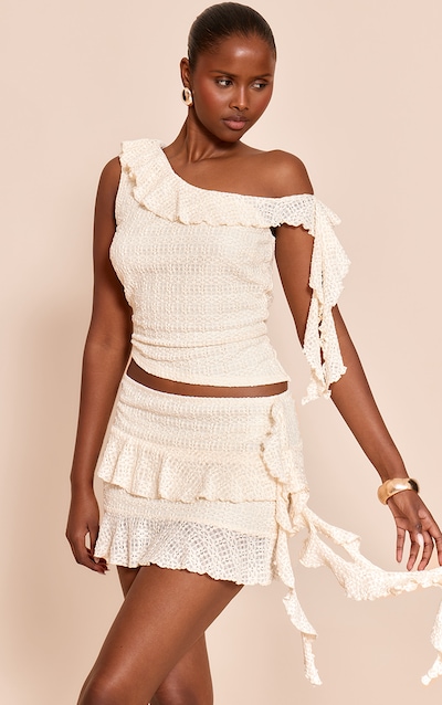 Top en dentelle crème à col asymétrique