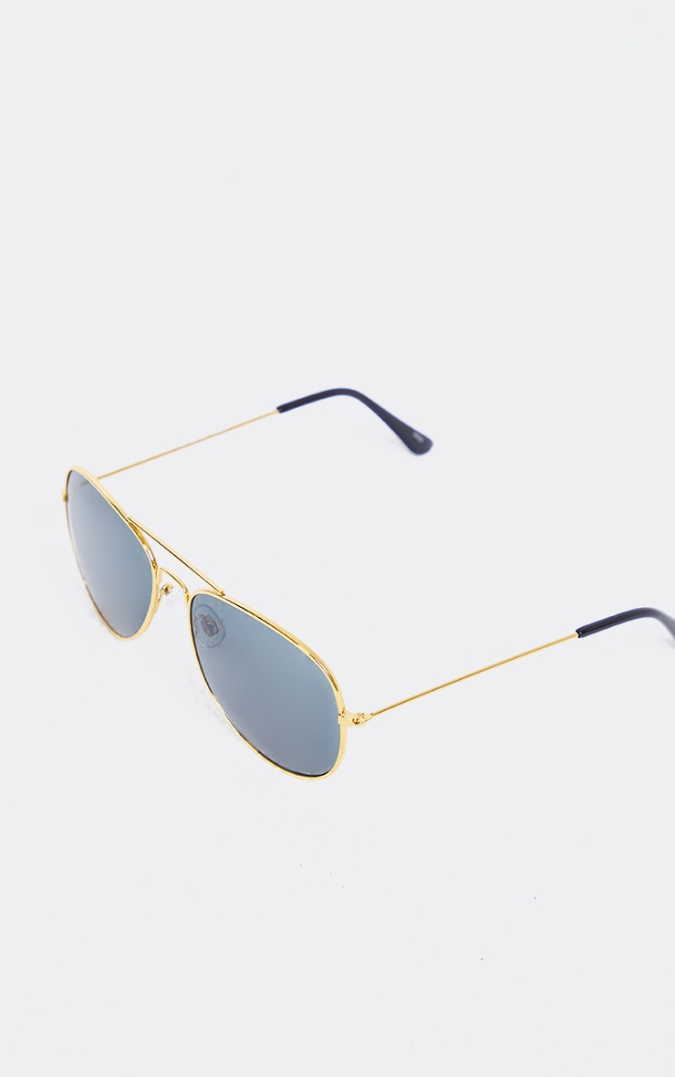 Lunettes style aviateur dorées à verres fumés
