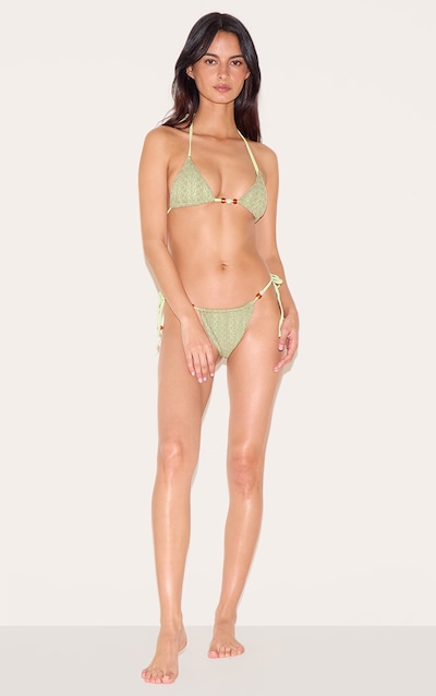 Bas de maillot de bain texturé vert sauge noué sur les côtés à détail perles