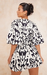 Black Print Plunge Puffball Hem Playsuit | PrettyLittleThing