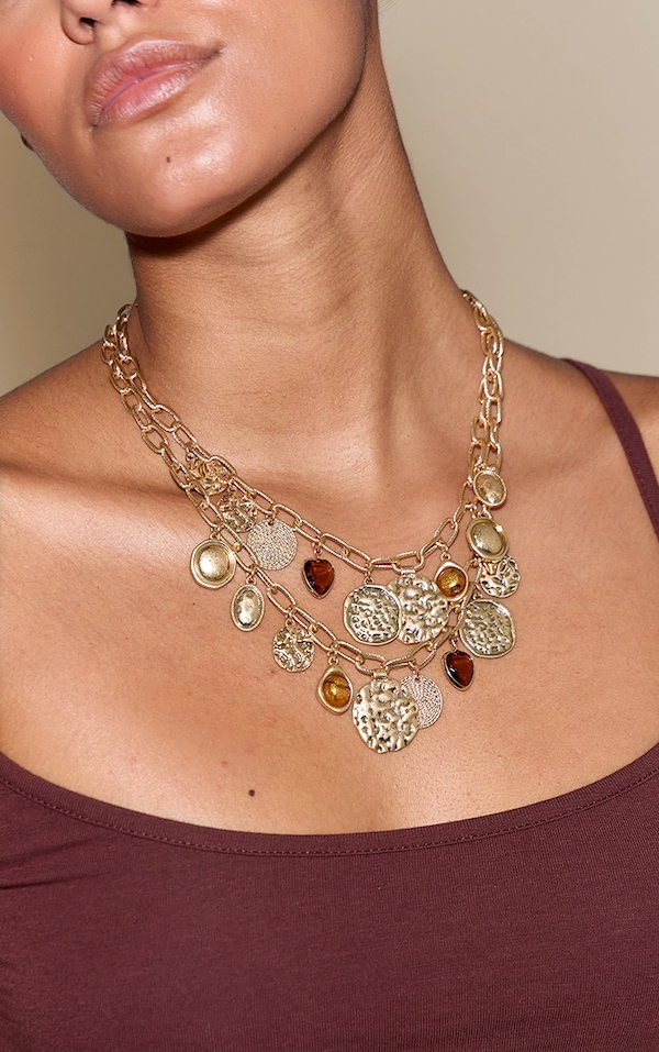 Collier superposé doré à breloques multiples