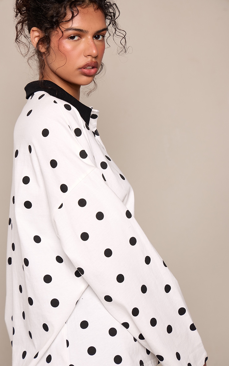 Top style rugby noir et blanc imprimé pois à col polo et manches longues