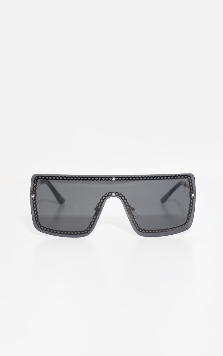 Lunettes de soleil réfléchissantes noires à monture plate dorée