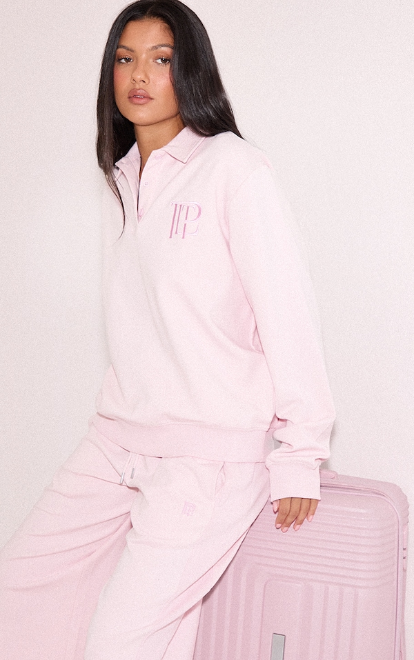 Sweat polo doublé rose à logo brodé et boutons