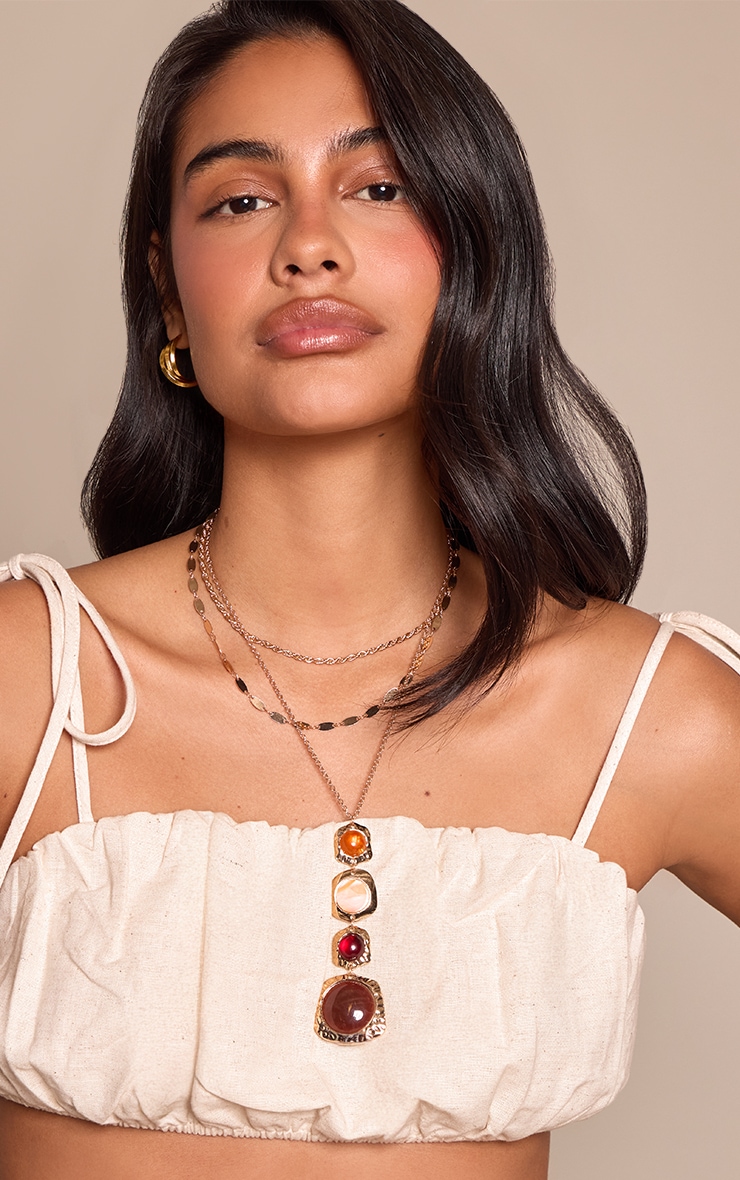 Collier superposé doré à pendentifs pierres multicolores