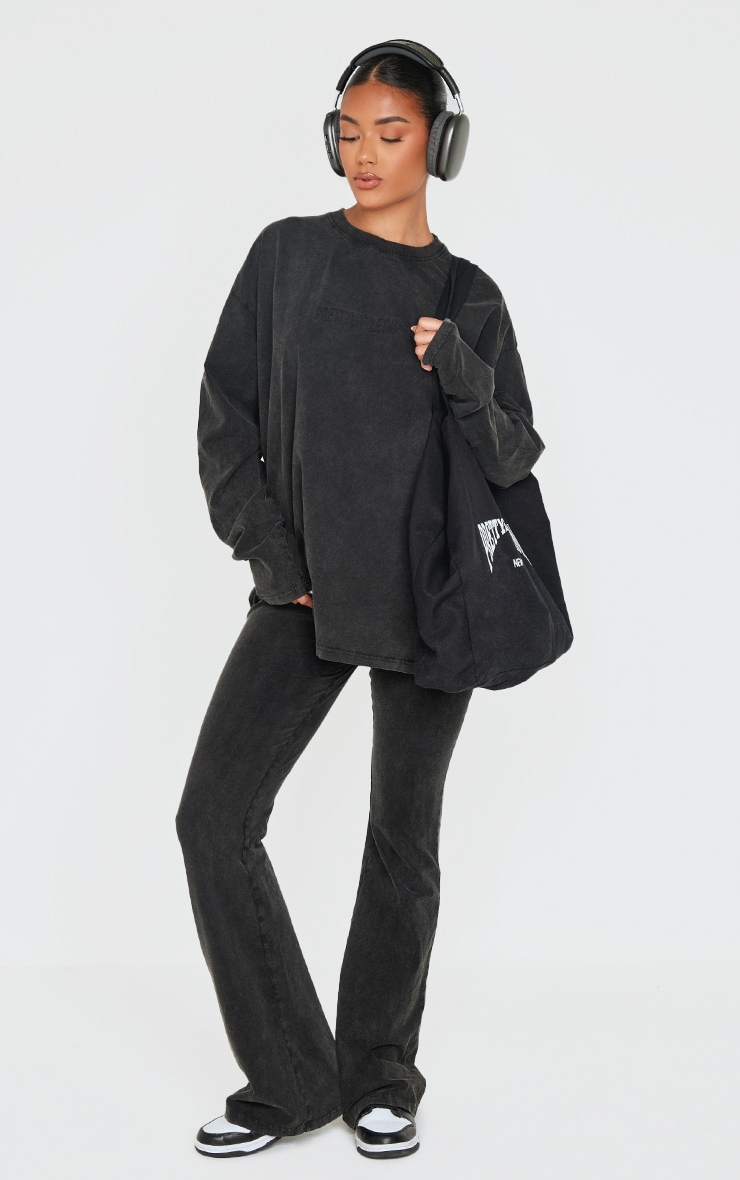 PRETTYLITTLETHING Black Embossed Logo Washed Skinny Flare Pants image 1