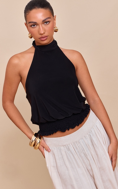 Top moulant doublé noir à dos nu et ourlet froncé