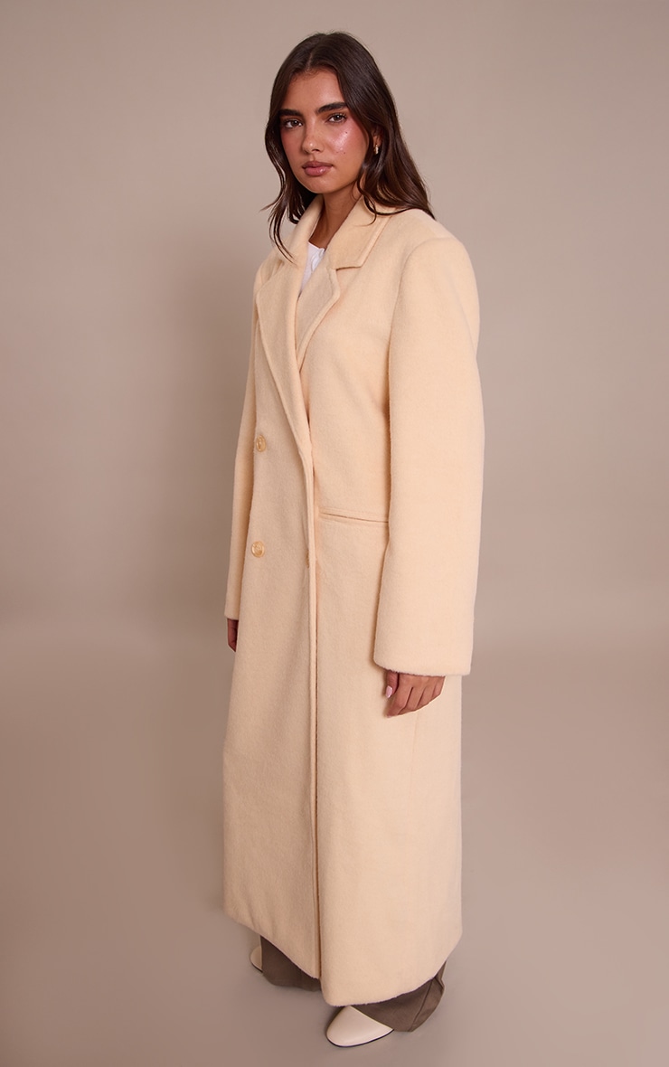 Manteau long structuré en effet laine crème au beurre à double boutonnière image 3