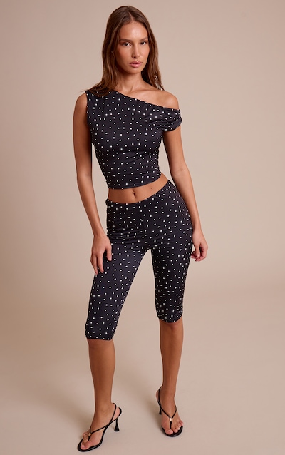 Pantalon capri moulant noir à pois et taille basse