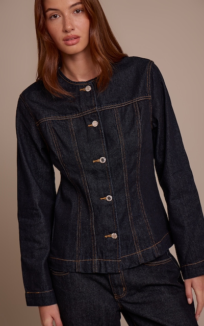Veste cintrée en jean indigo foncé délavé à coutures structurantes et manches longues