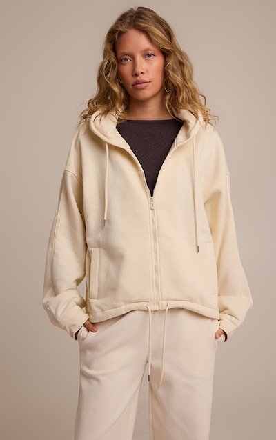 Sweat à capuche oversize zippé crème en maille tricot avec cordon de serrage à la taille.