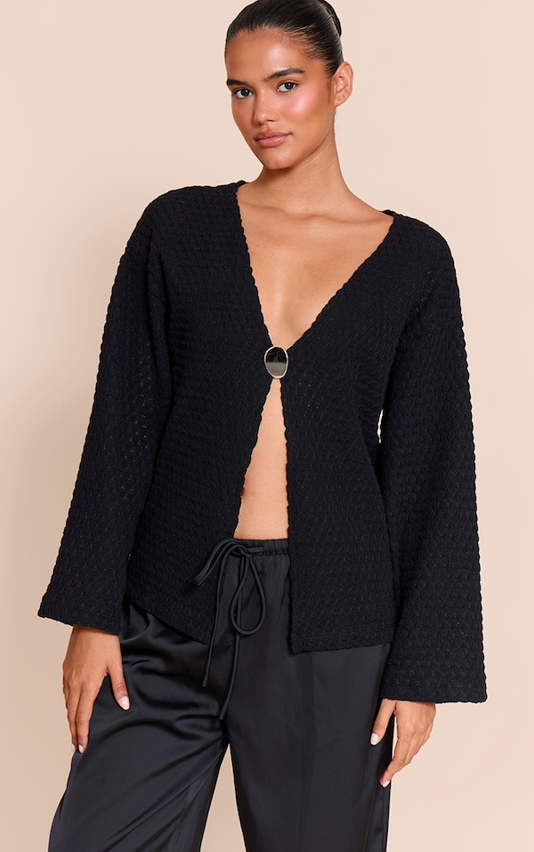 Top oversize texturé noir à manches longues et empiècement