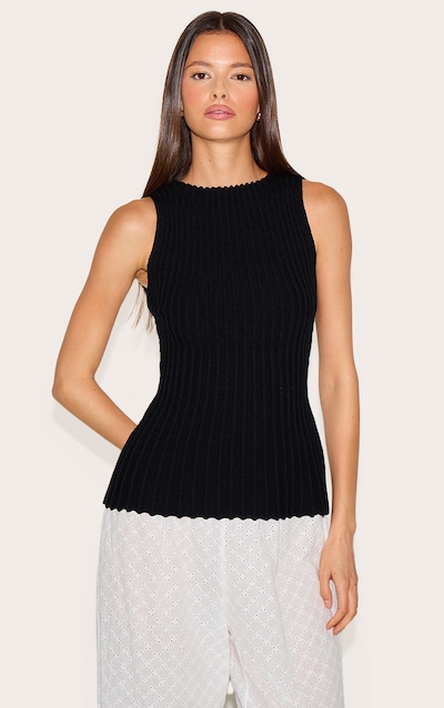 Top péplum en maille tricot noire à col bateau