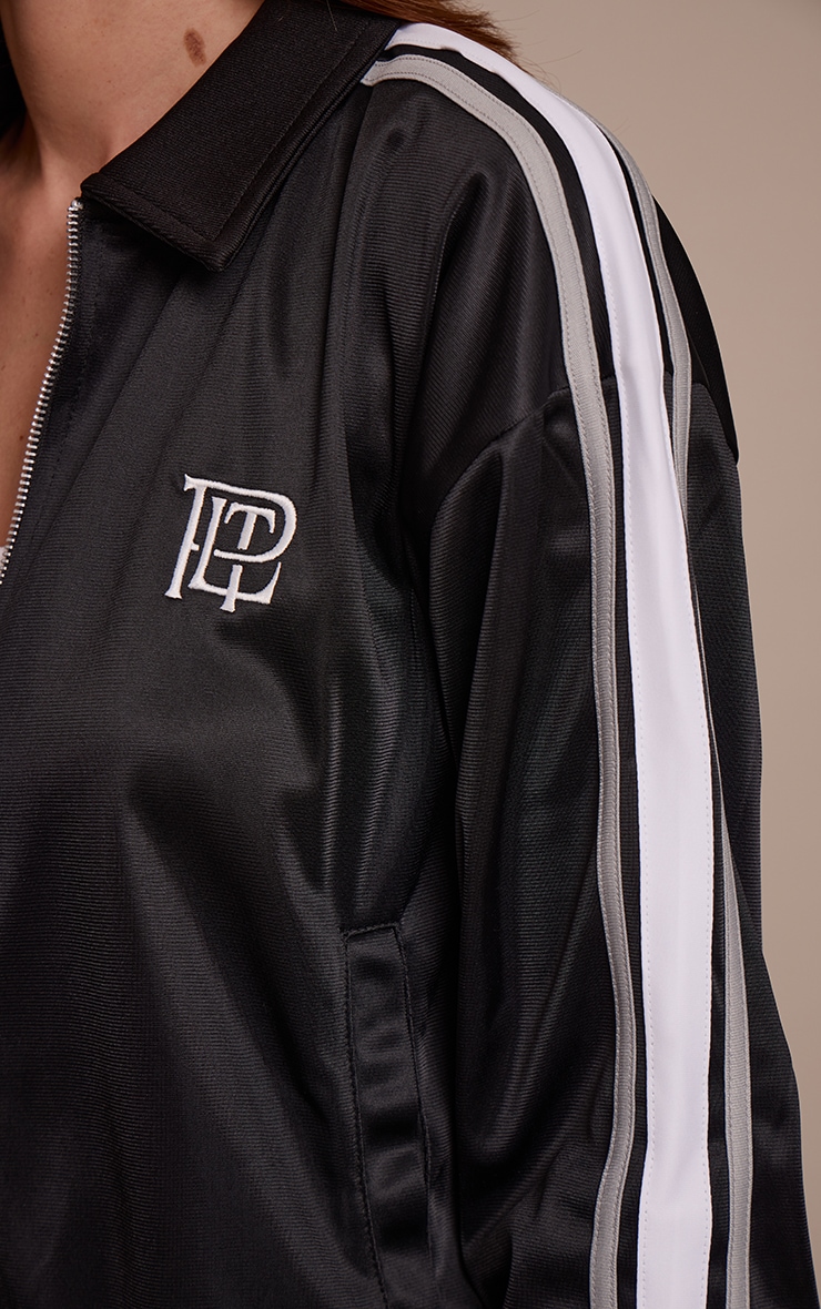Veste noire à zip et rayures contrastantes sur les côtés image 4
