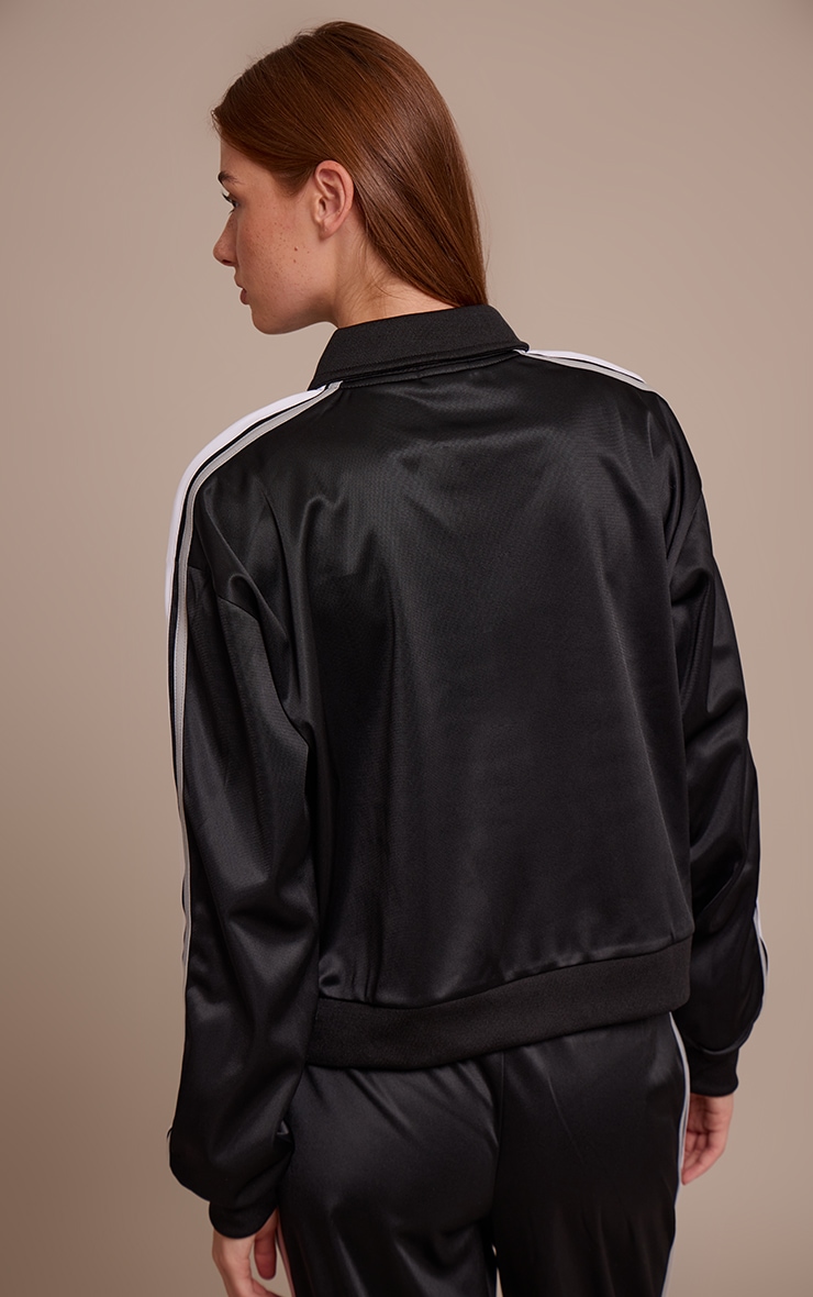 Veste noire à zip et rayures contrastantes sur les côtés image 2