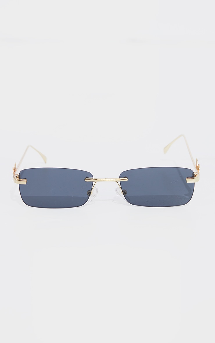 Lunettes de soleil à verres noirs et monture dorée avec détail papillon image 2