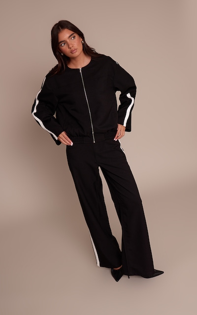 Pantalon tailleur noir rayé à jambe droite