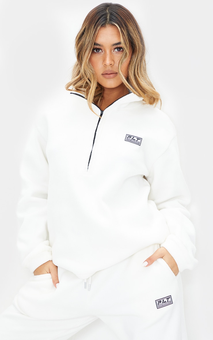 PRETTYLITTLETHING Cream Soft Touch Badge Detail Funnel Neck Sweater