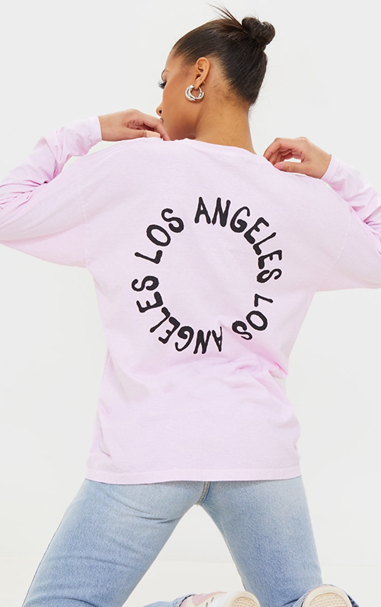 Tee-shirt manches longues rose pâle délavé à imprimé L.A. au dos
