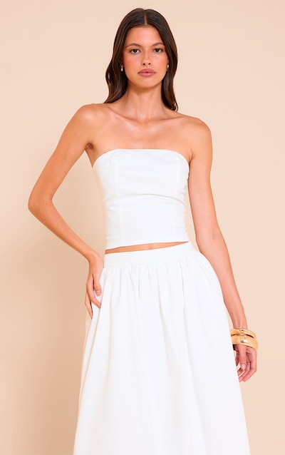 Haut bandeau tissé blanc avec détail de couture.