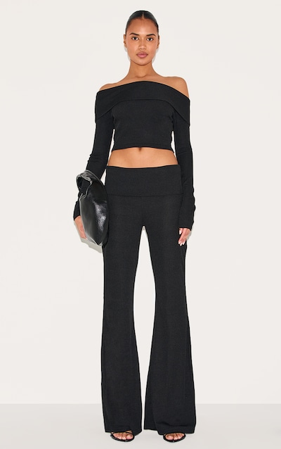 Pantalon flare côtelé noir à détail replié et taille basse