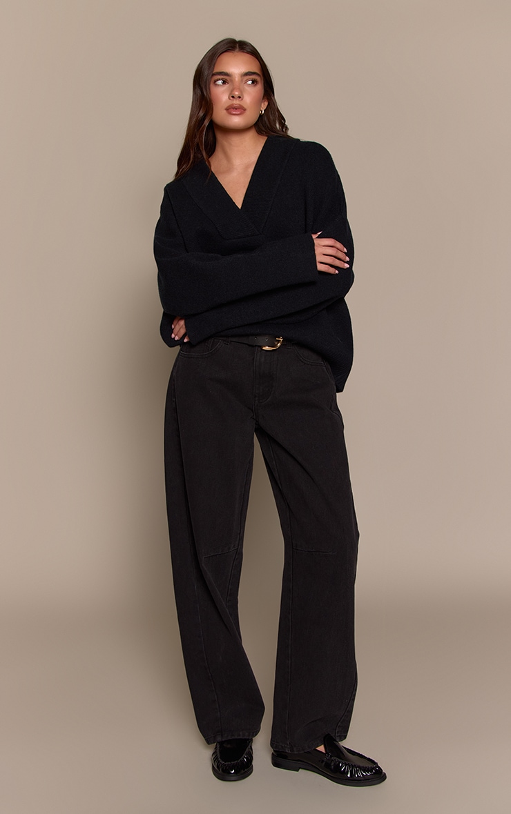 Jean bouffant noir à taille basse et lisérés devant