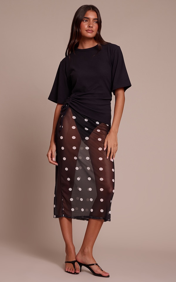 Jupe mi-longue en mesh noir à pois