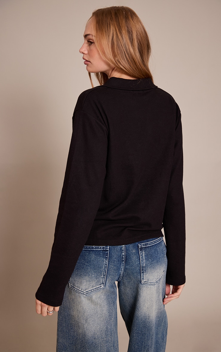 Top long noir à col replié et logo brodé image 2