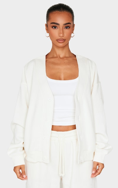 Petite Sweat crème à boutons et poches sur les côtés